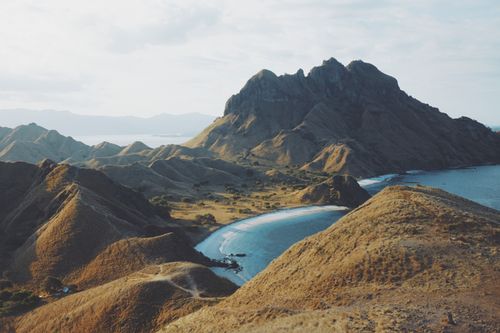 Free A breathtaking aerial shot of Padar Island's rugged landscape and serene beaches in Indonesia. Stock Photo