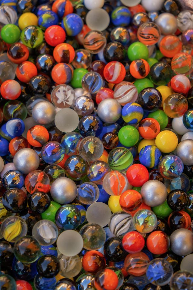 Close-up of colourful swirled glass marbles — photo by Ilo Frey on Pexels