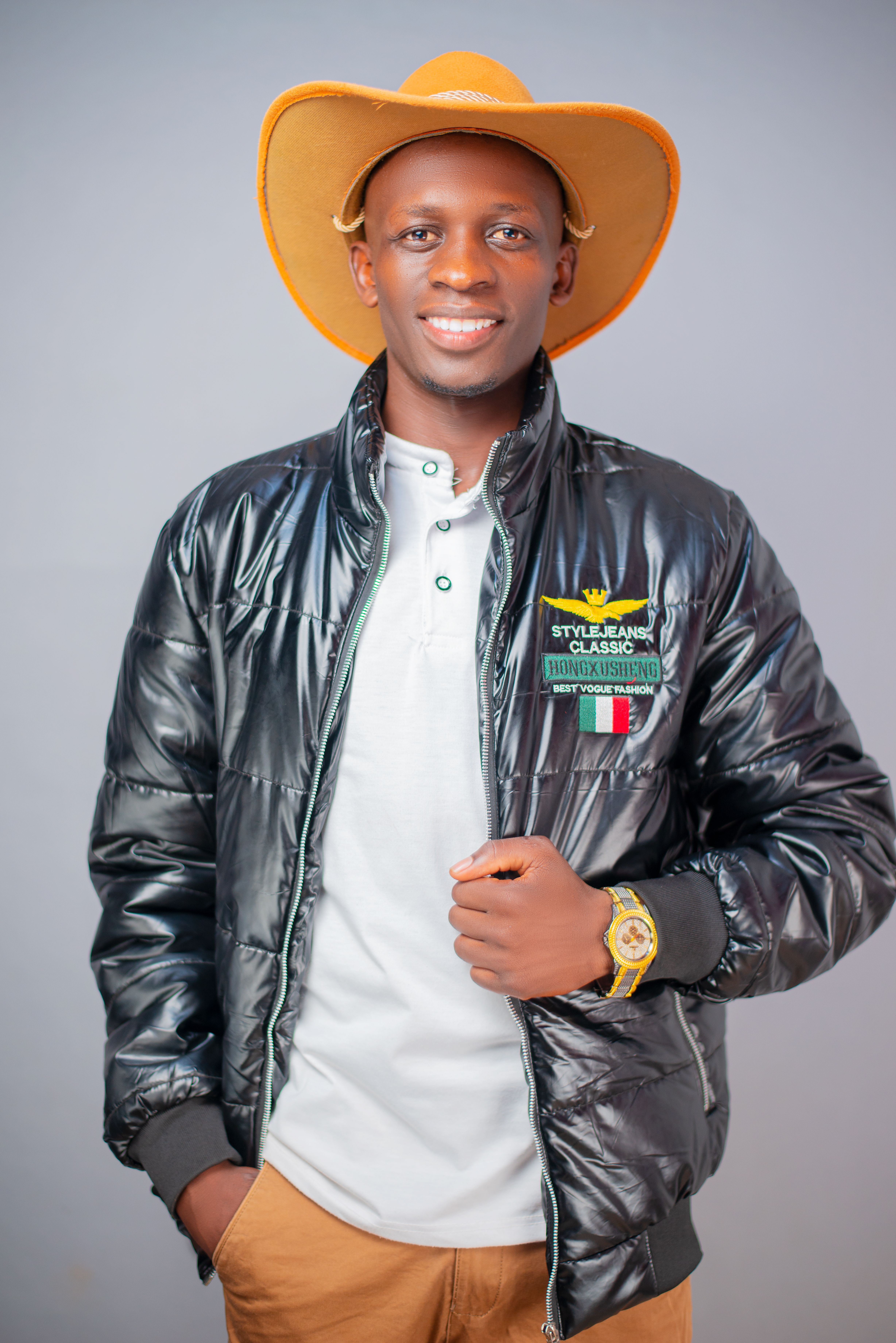 Portrait of a cheerful young man in a stylish jacket and cowboy hat, Kenya