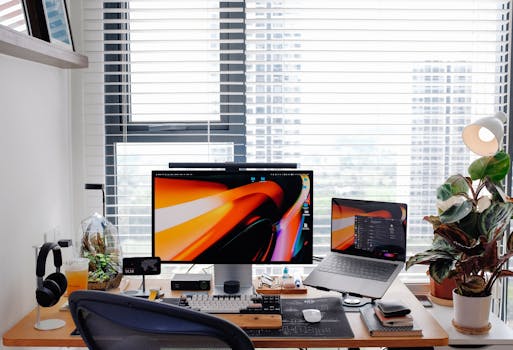 Stylish home office setup featuring a laptop, monitor, and desk accessories.