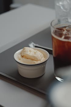 Close-up of an iced coffee and ice cream on a table, perfect for a refreshing treat.