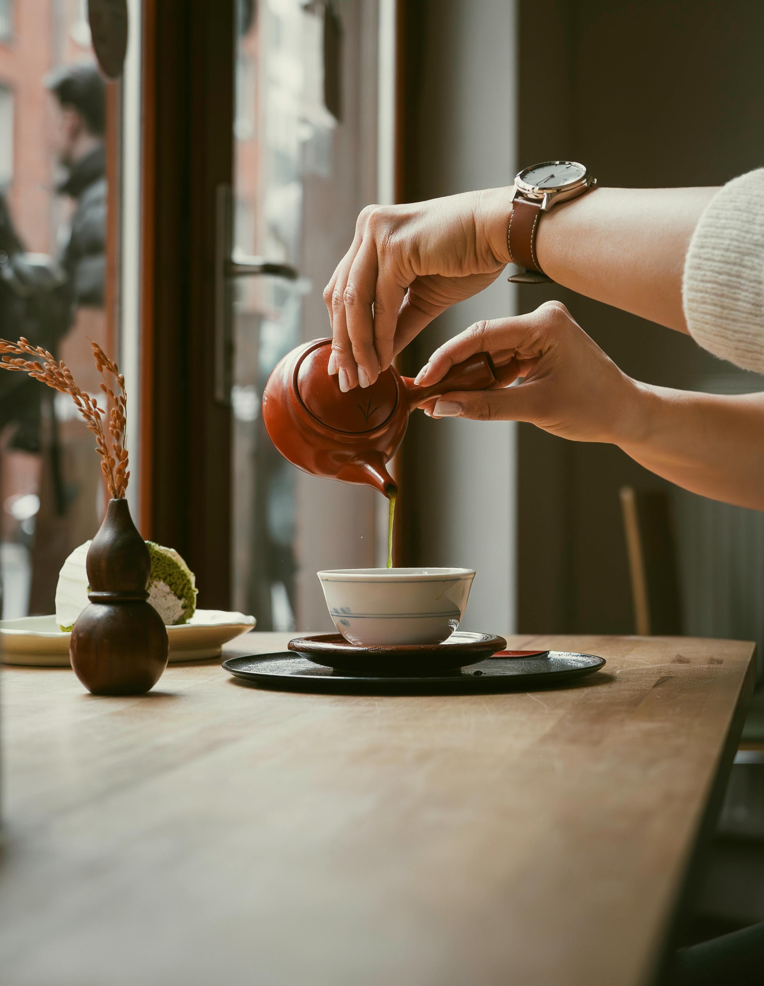 Captured moment of a traditional Japanese matcha tea ceremony in a Berlin café, showcasing cultural elegance.