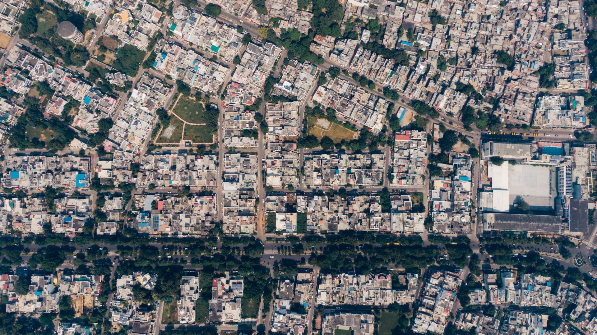 Overhead view of a densely packed city neighborhood with a central park.