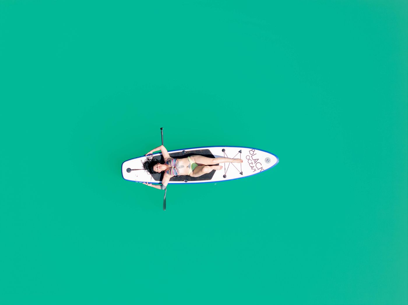 Paddleboarder exploring open water