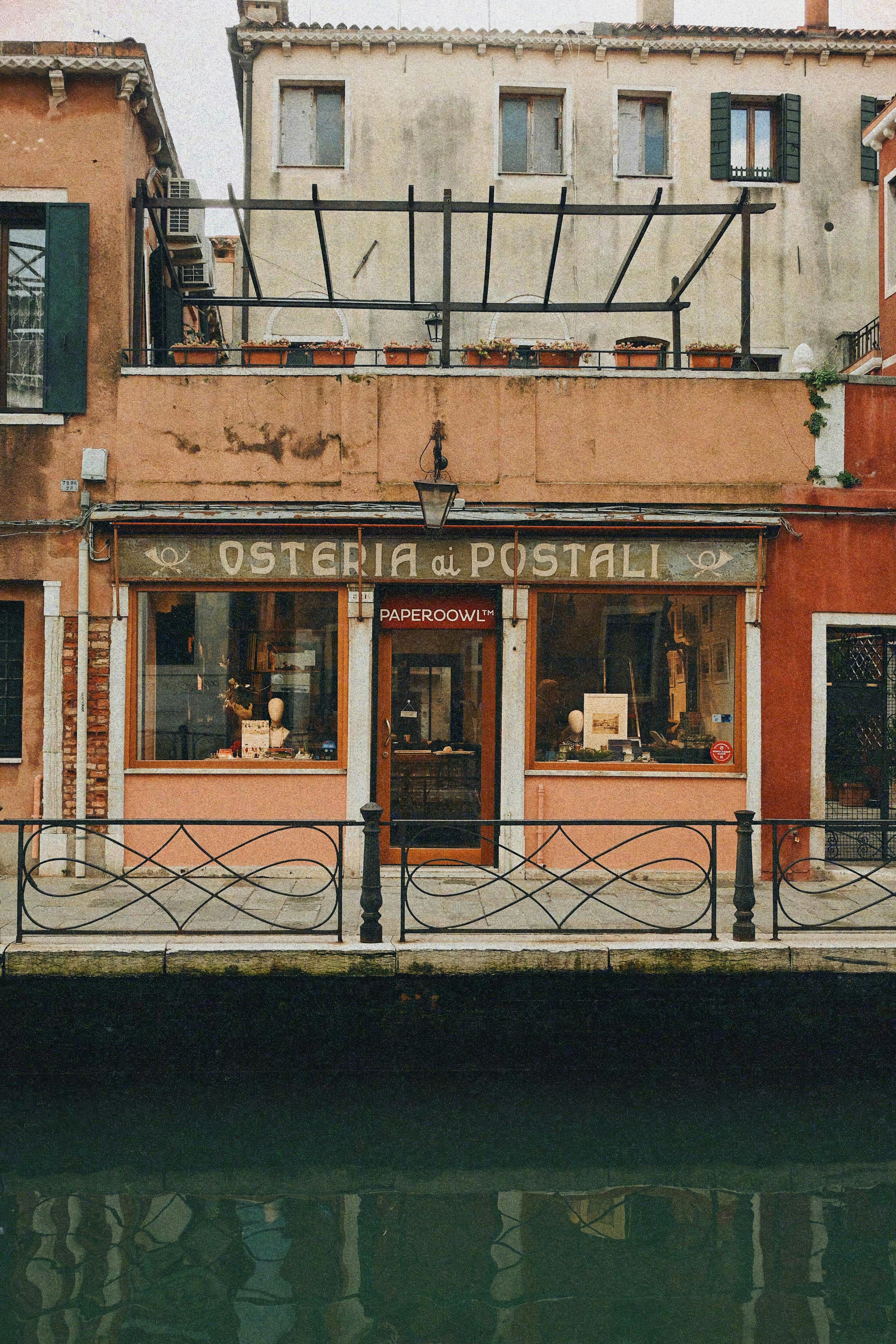 Charming Venetian storefront by a canal in Venice, Italy.