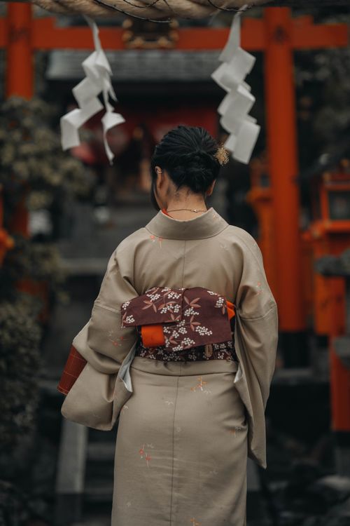 Free Rear view of a Japanese woman in a kimono at a traditional Kyoto temple setting. Stock Photo