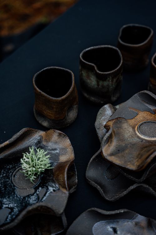 Free Unique handmade ceramic pieces with organic shapes and rustic finish in dark tones. Stock Photo