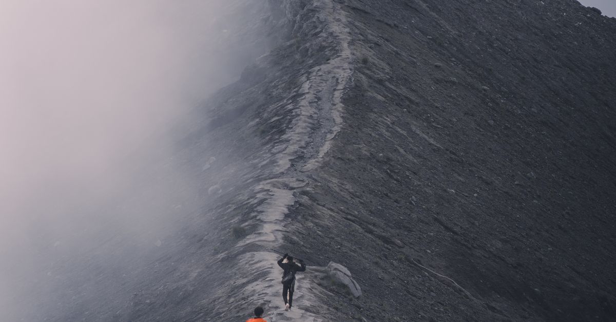 Misty Ridge Trail Adventurers Hiking a Misty Mountain Ridge · Free Stock Photo