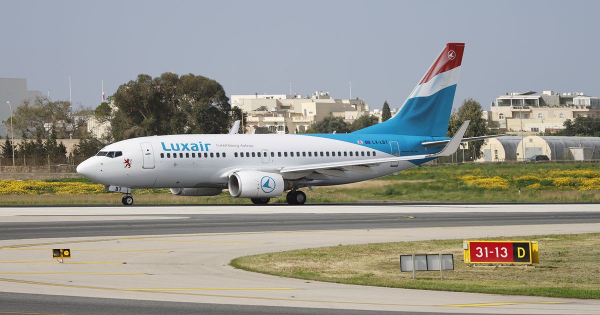 A passenger jet on an airport runway.