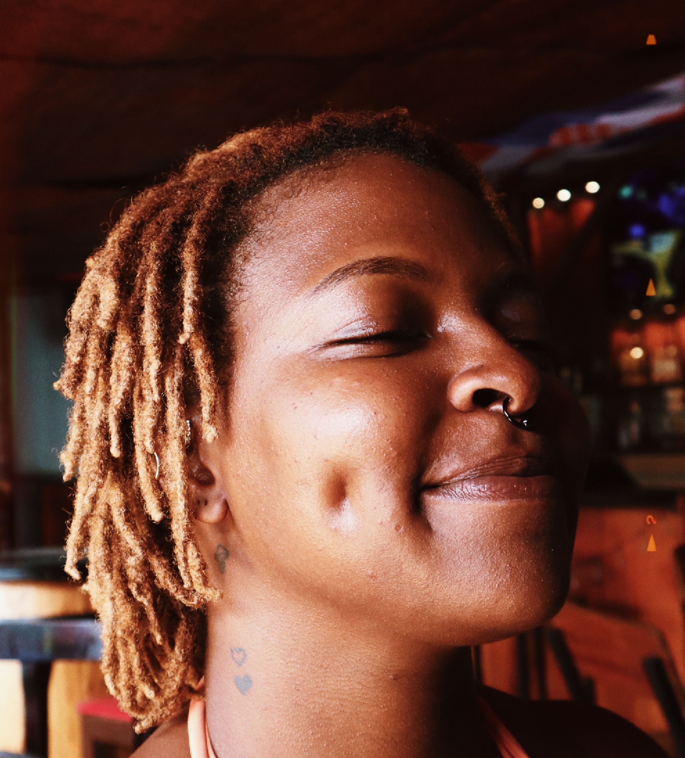 Joyful Portrait of Woman with Dreadlocks in Café · Free Stock Photo