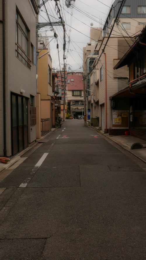 Free Serene city street in Japan with traditional architecture and overhead wires. Stock Photo