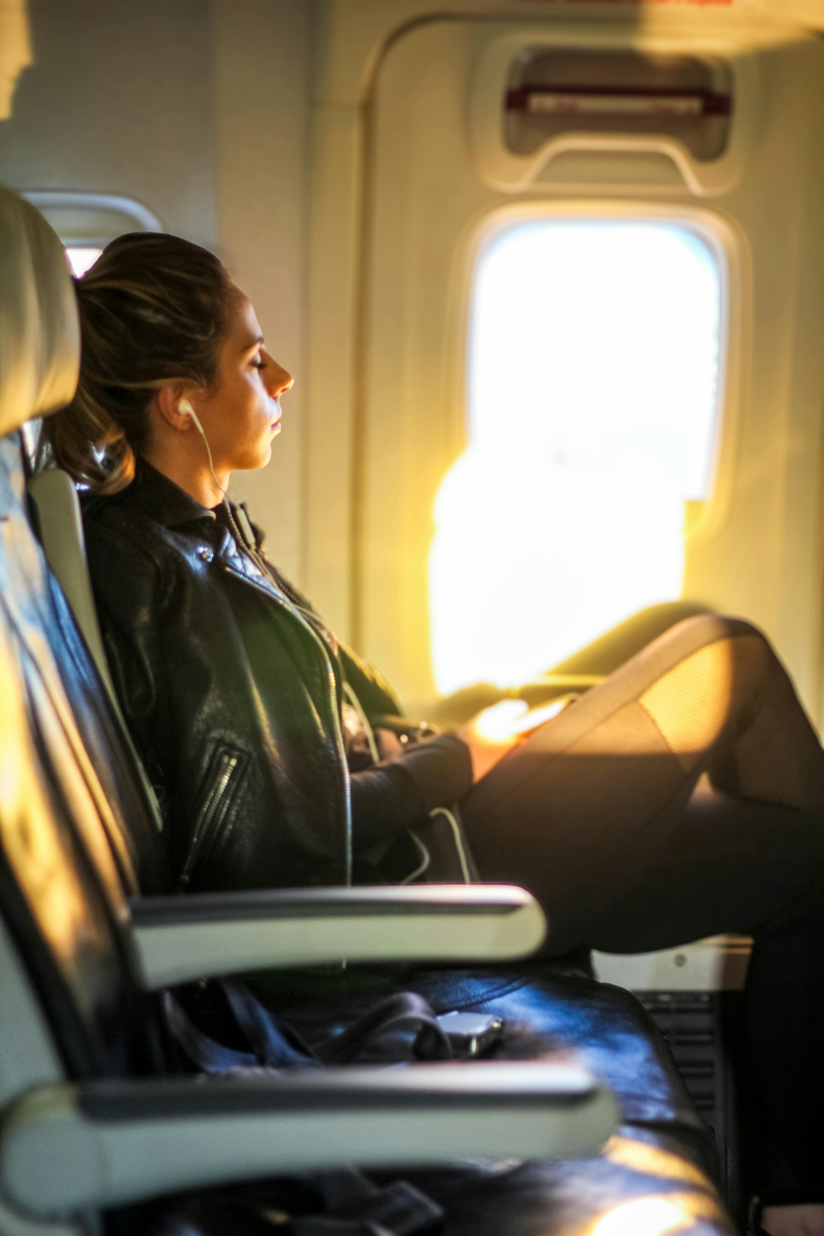 Passenger relaxing by an airplane window, highlighting the idea of doing one calm touch-up near landing