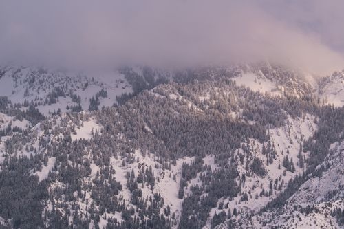 Free A serene view of the snow-covered Wasatch Mountains in Salt Lake City, Utah at sunset. Stock Photo