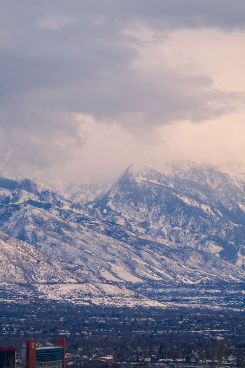 Free Breathtaking view of the Wasatch Mountains dusted with spring snow at sunset in Salt Lake City, Utah. Stock Photo