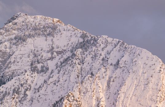Beautiful snow-covered Wasatch Range in Salt Lake City during spring sunset. Captivating winter scene.