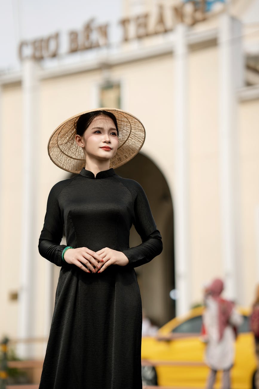Woman in Ao Dai with Non La at Ben Thanh Market, Vietnam.