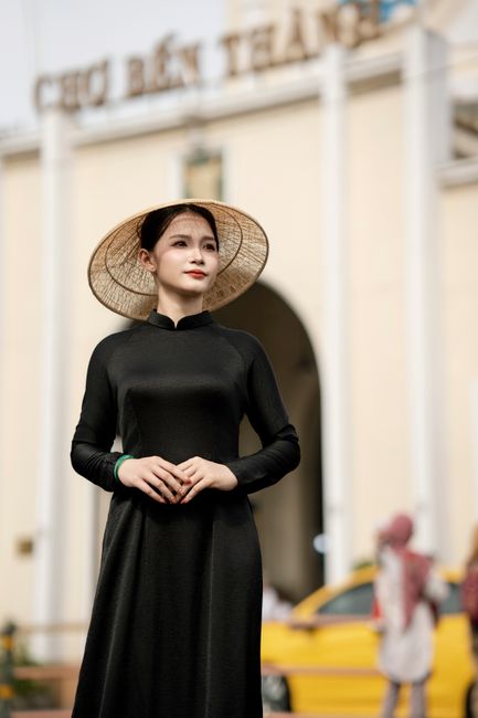 Woman in Ao Dai with Non La at Ben Thanh Market, Vietnam.