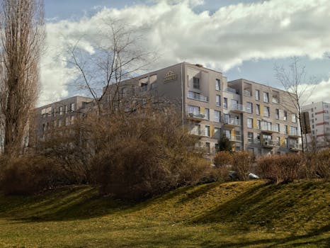 Contemporary apartment complex amidst landscaped greenery in Zielona Góra, Poland.