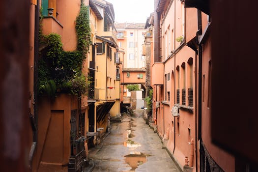 Charming narrow alley in Italy with colorful architecture and greenery.