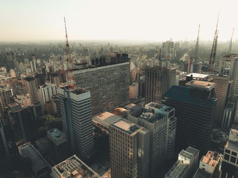 Aerial shot of São Paulo skyline featuring modern skyscrapers and clear skies.