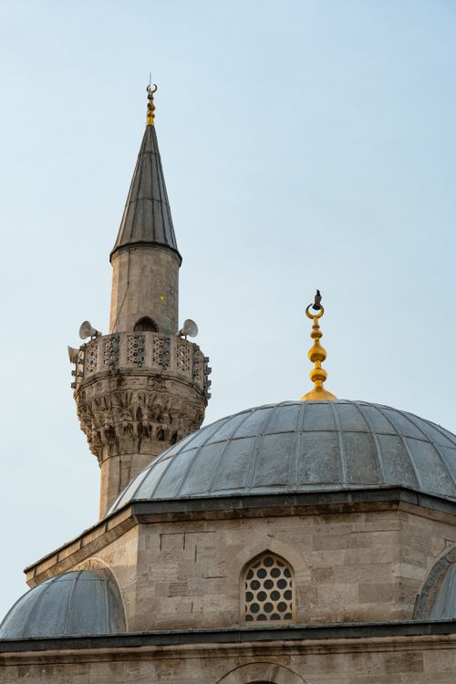Free A stunning mosque minaret and dome extend gracefully into the sky, showcasing Islamic architecture. Stock Photo