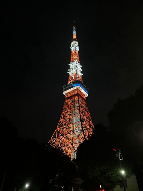 Free Stunning view of Tokyo Tower glowing in the night sky, showcasing its iconic architecture. Stock Photo