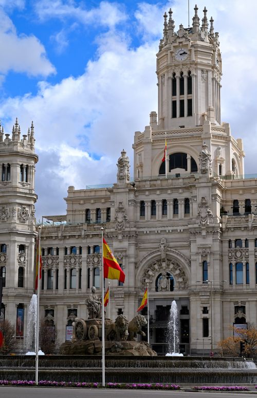 Free View of the iconic Cibeles Fountain and Palace, Madrid, during daytime. Stock Photo