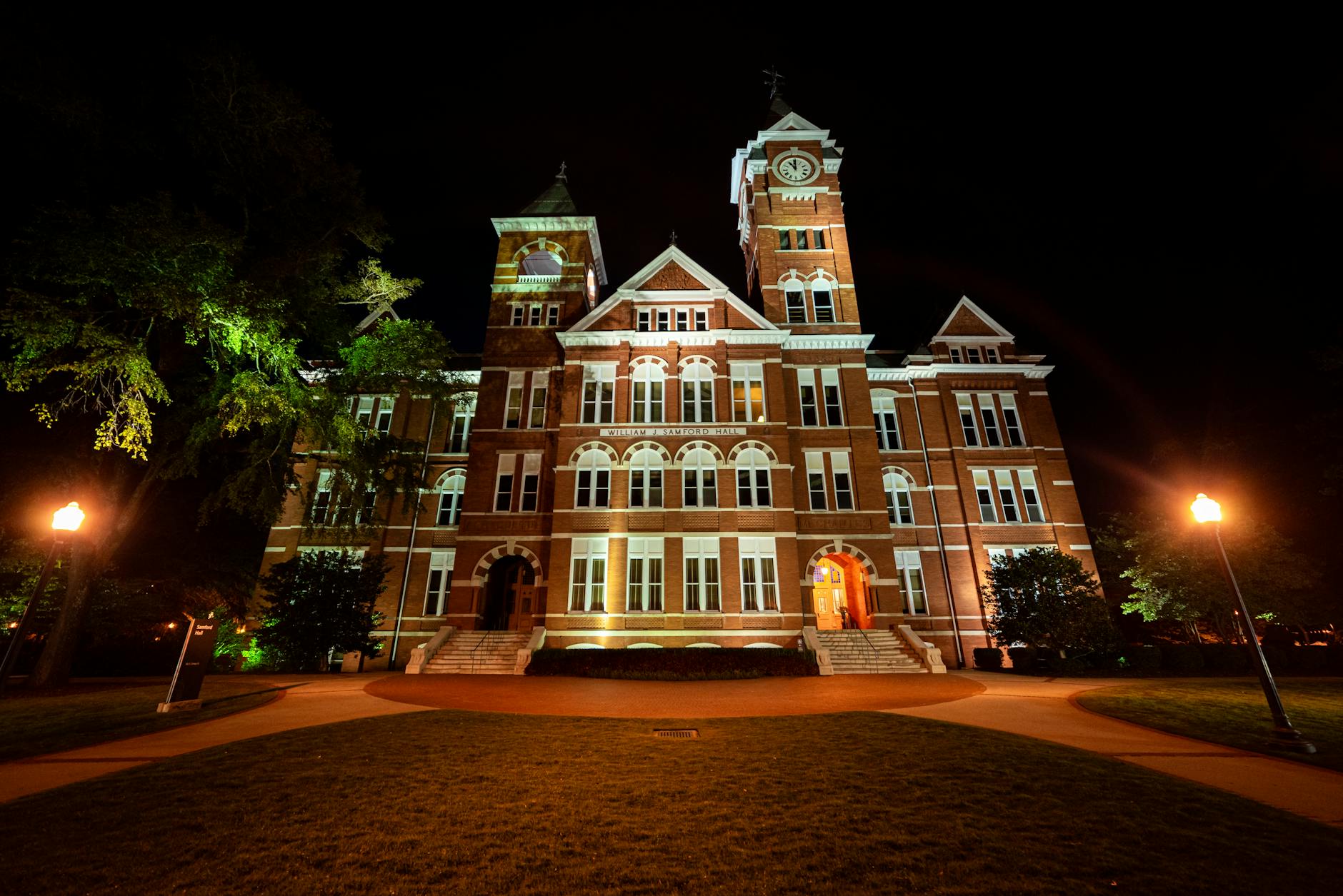 Illuminated view of Samford Hall, Auburn University at night, capturing the historic architecture beautifully.