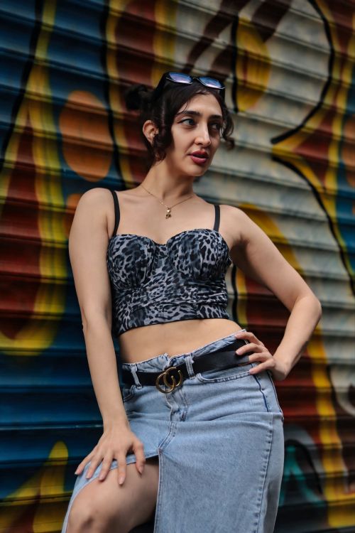 Free Fashionable woman in leopard print pose against colorful graffiti wall. Urban style. Stock Photo