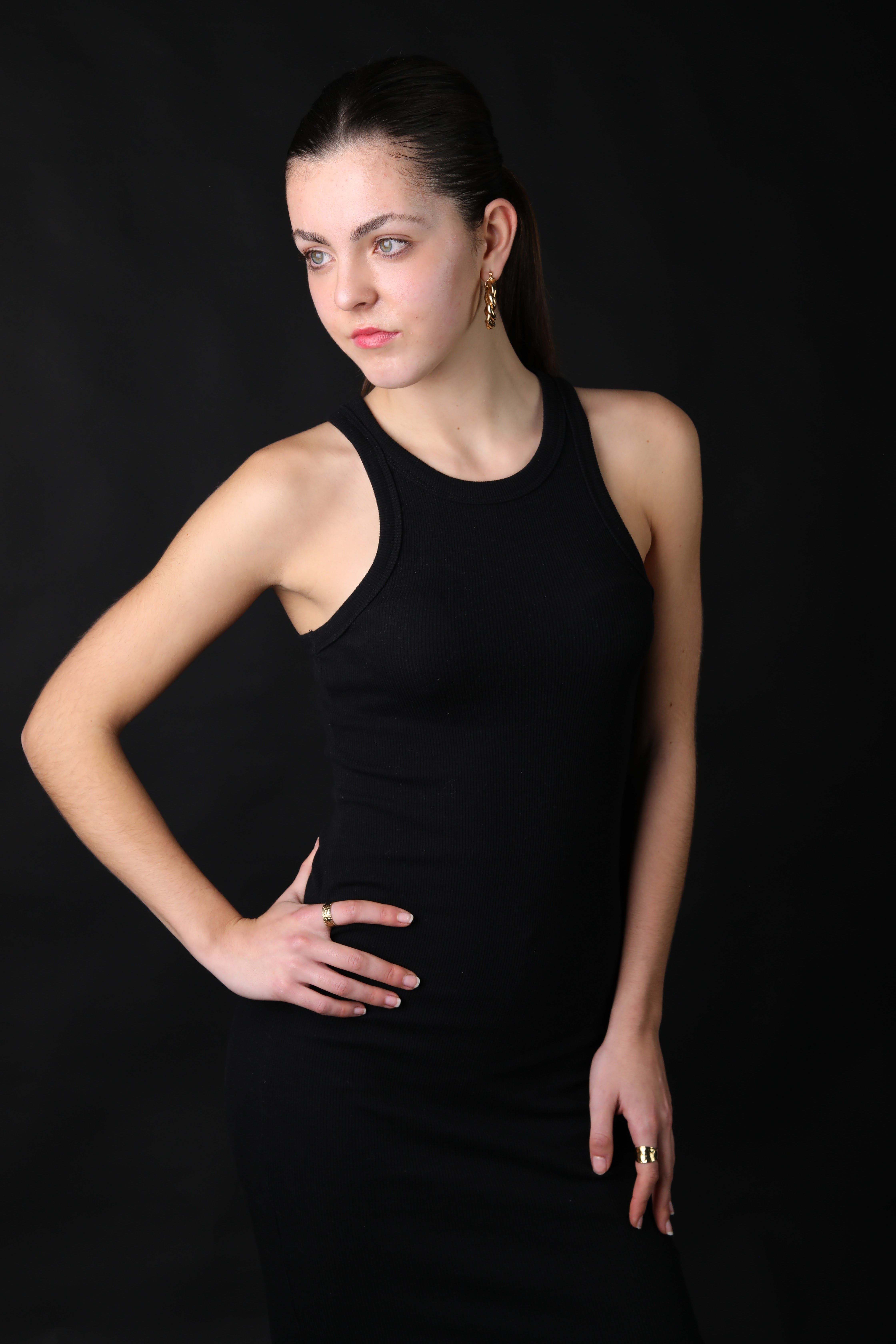 Elegant Woman Posing in Black Dress Against Dark Background · Free ...
