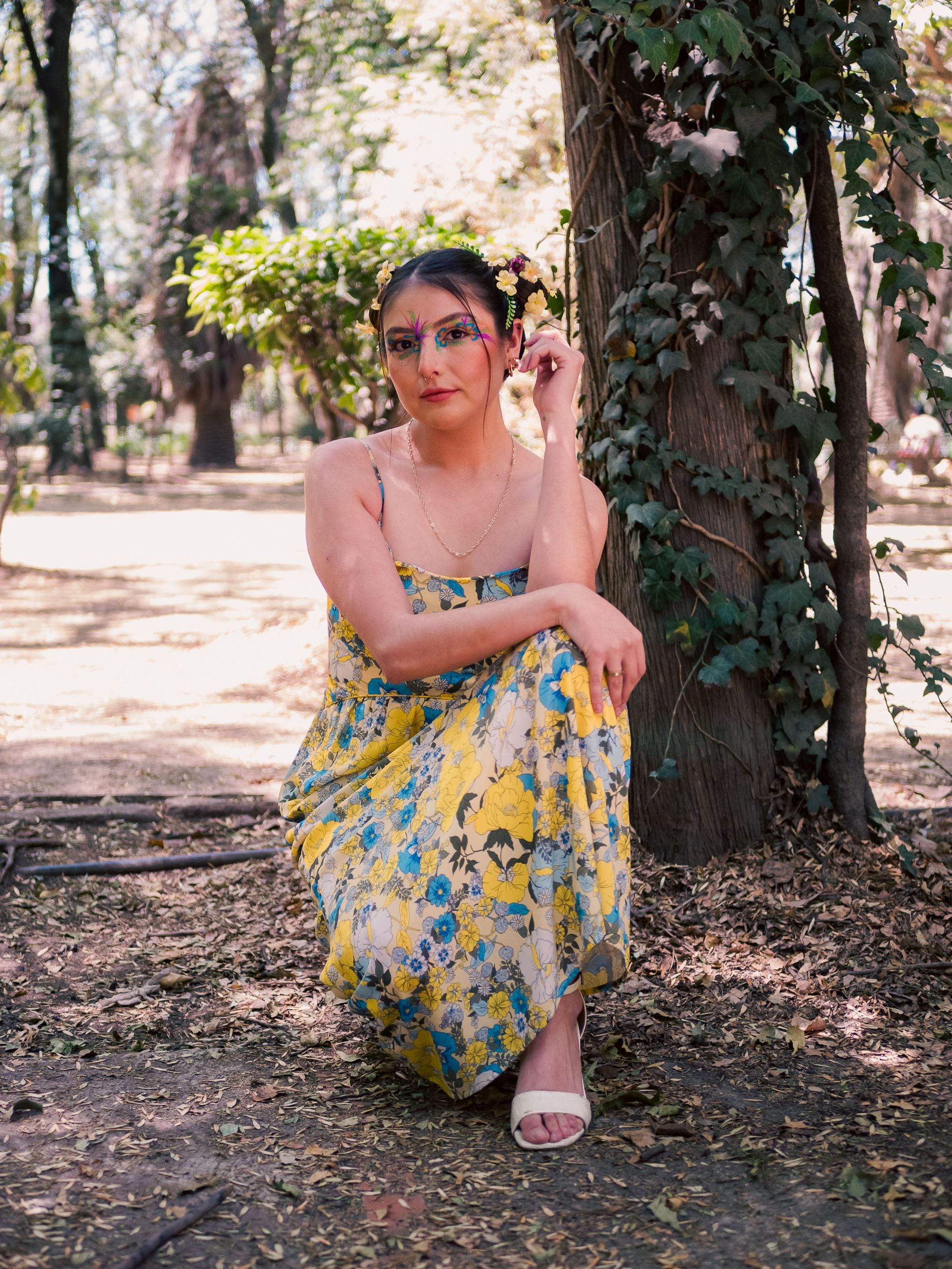 Woman in Floral Dress Poses in Sunny Park · Free Stock Photo