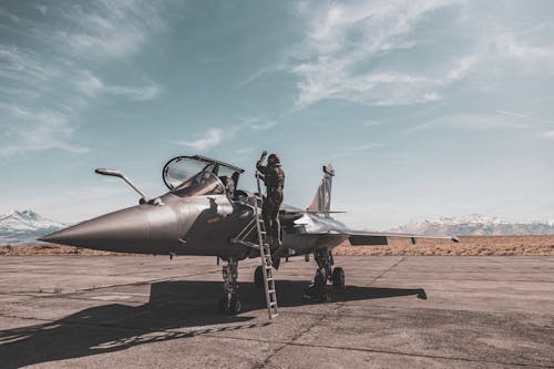 Free Photo Of Person Standing Beside Fighter Jet Stock Photo