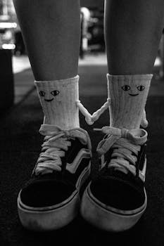 A stylish pair of socks with cartoon faces paired with sneakers, captured in Sete Lagoas, Brazil.