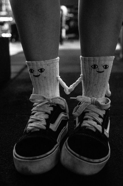 A stylish pair of socks with cartoon faces paired with sneakers, captured in Sete Lagoas, Brazil.