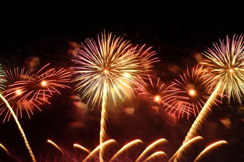 Free Colorful fireworks explode brilliantly against a dark night sky. Stock Photo