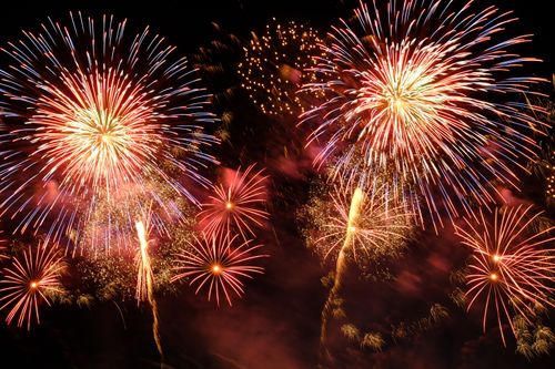 Free Colorful fireworks burst in a vivid display against a dark night sky, celebrating festivities. Stock Photo