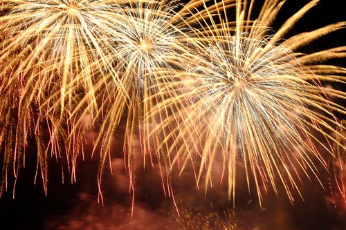 Free Brilliant fireworks display lighting up the night sky in golden hues. Stock Photo