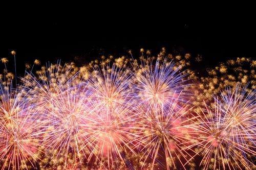 Free Vibrant fireworks exploding in a dazzling night sky spectacle. Stock Photo