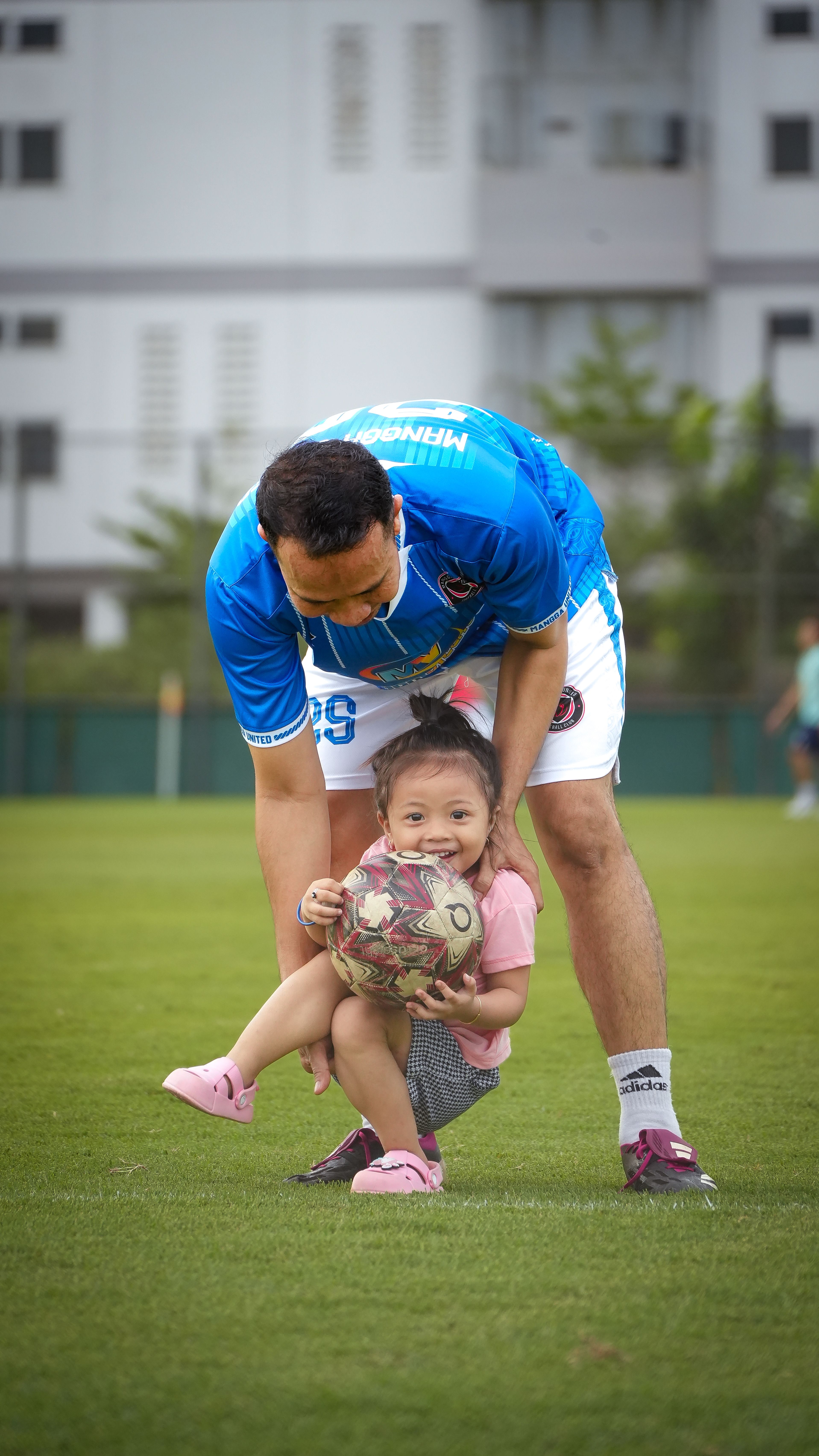 Father and Daughter Playing Football in Jakarta Park