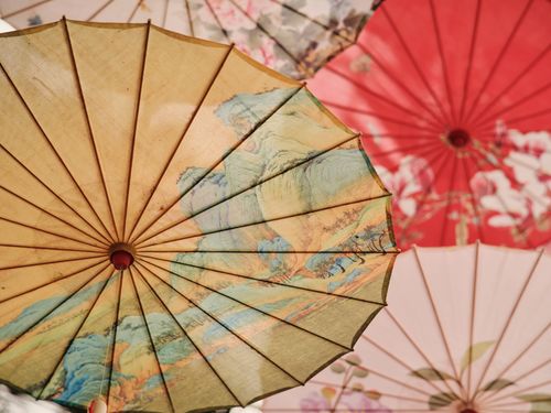 Free Artistic view of colorful umbrellas displaying intricate floral patterns. Stock Photo