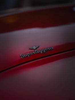 Detailed focus on Superleggera badge on a sleek red car evoking nostalgia and luxury.