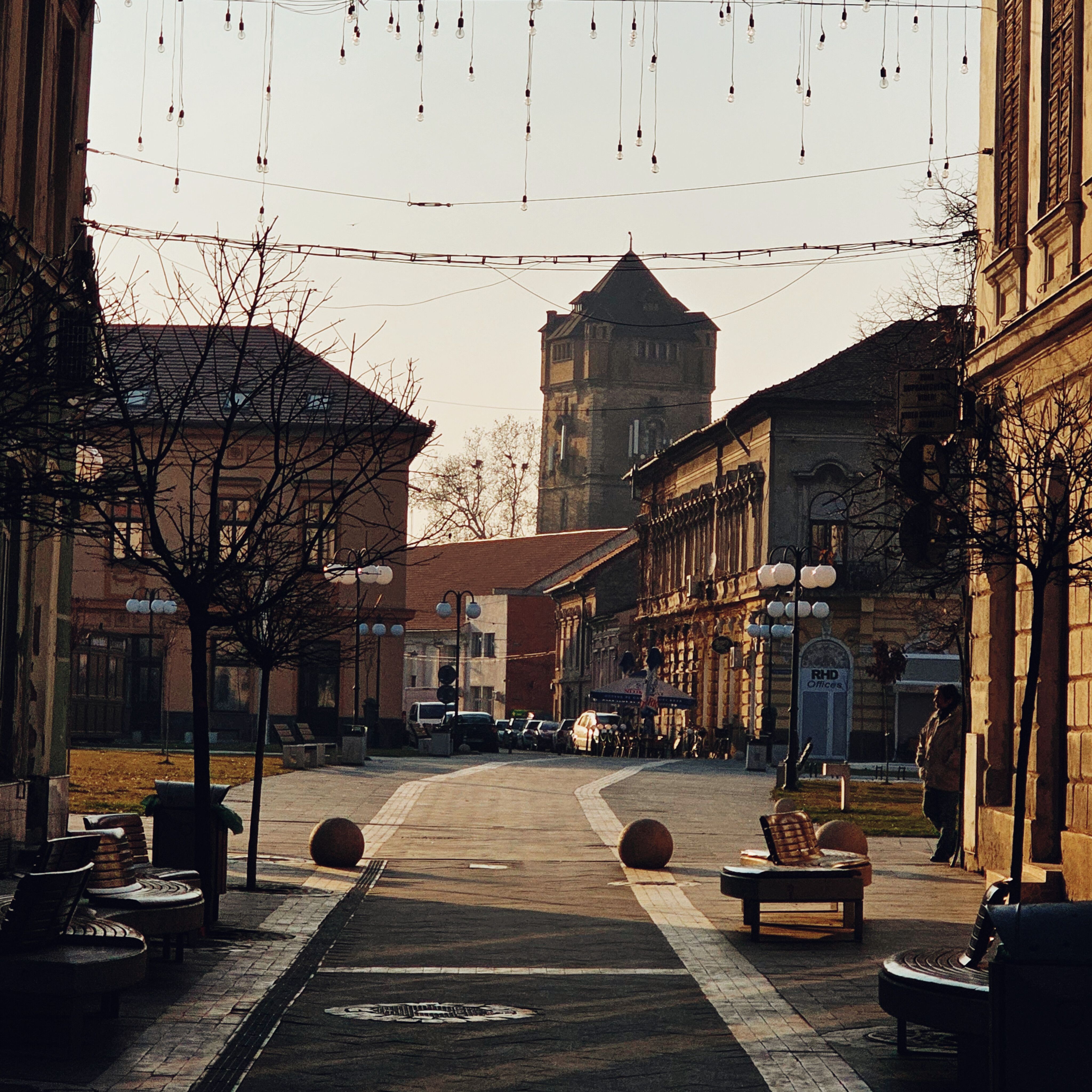 Charming street scene with vintage architecture and moody lighting captures European ambiance.