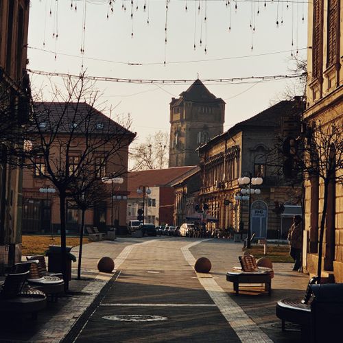Free Charming street scene with vintage architecture and moody lighting captures European ambiance. Stock Photo