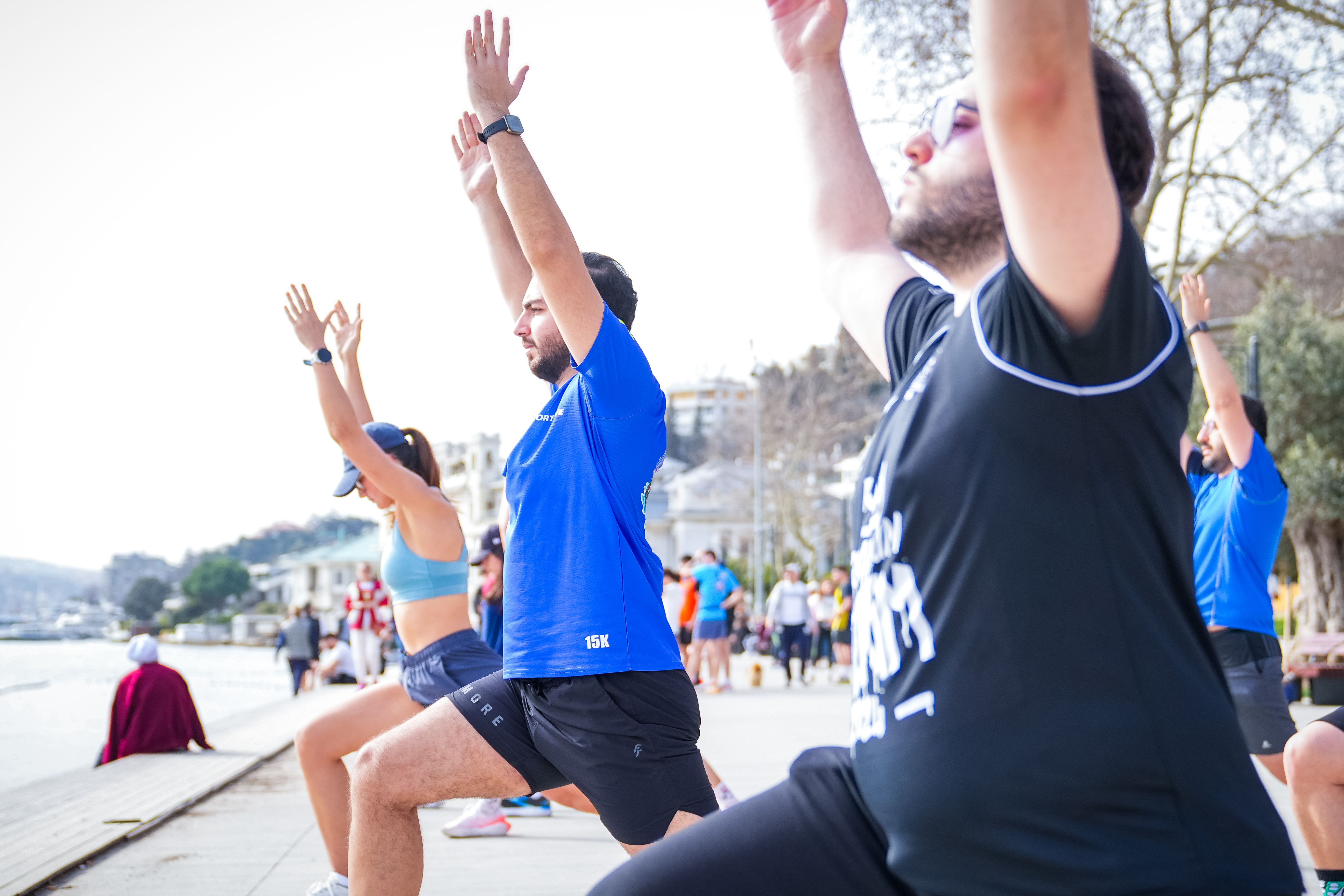 Women and men reconnecting during an outdoor waterfront wellness session