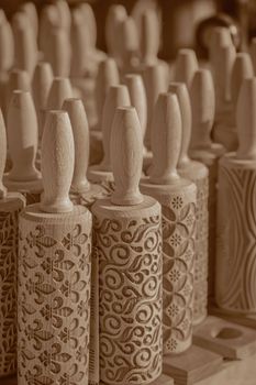 Artisan wooden rolling pins with detailed carvings, perfect for baking art.