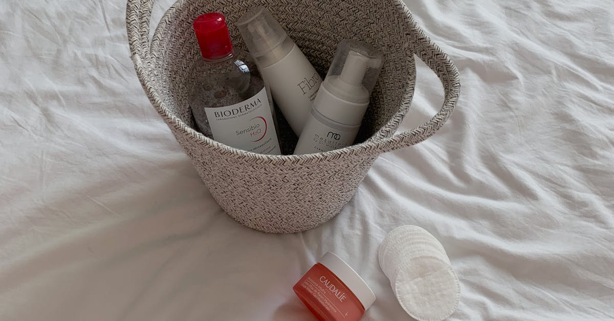 Different types of facial cleansers displayed on a shelf in a beauty store.