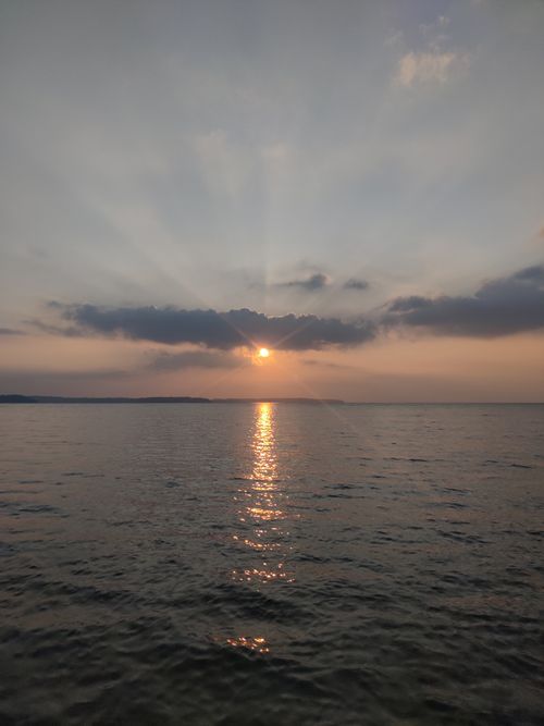 Free Peaceful sunset with sun reflecting over the Indian Ocean, capturing tranquility and beauty. Stock Photo