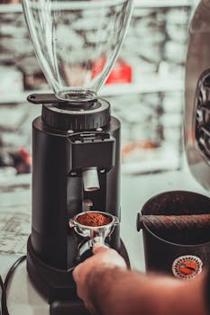 Close-up of barista grinding coffee in a cafe in Kermanshah, Iran.