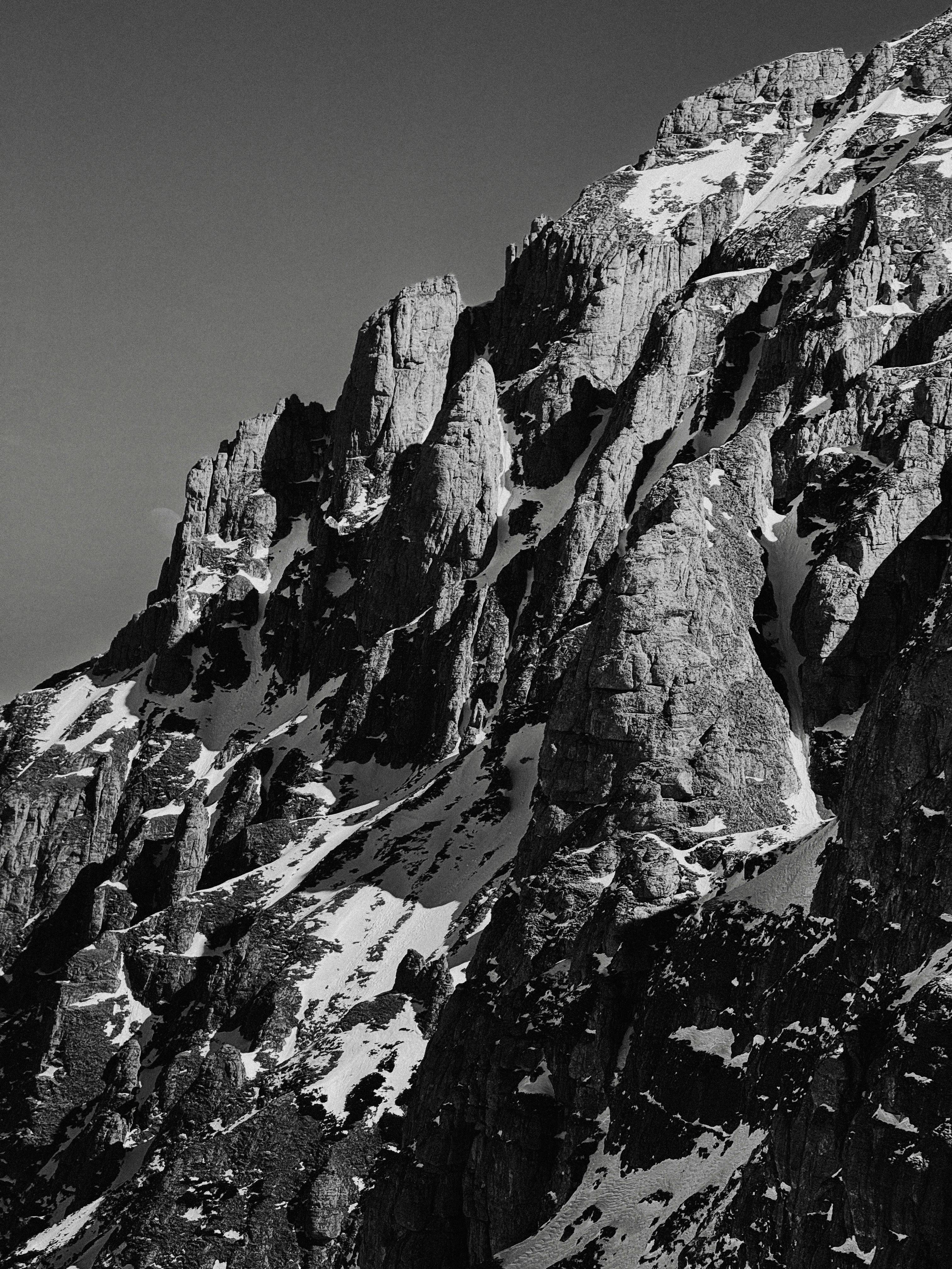 Striking image of rugged, snow-covered mountain peaks captured in monochrome.