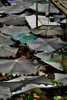 Colorful umbrellas cover a busy outdoor market, offering a vibrant scene of commerce.